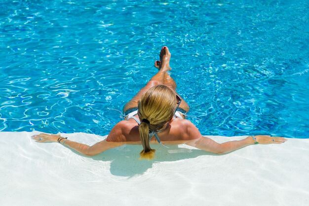 Woman relaxing in a maintained swimming pool