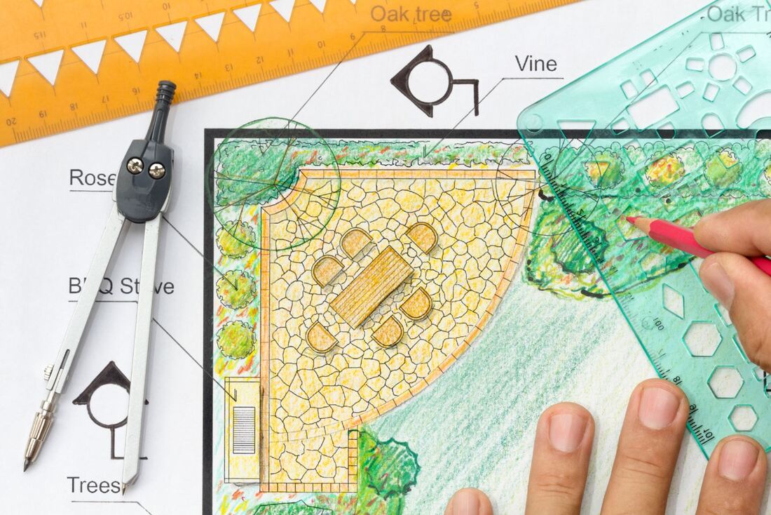 Landscaper drawing up a garden plan
