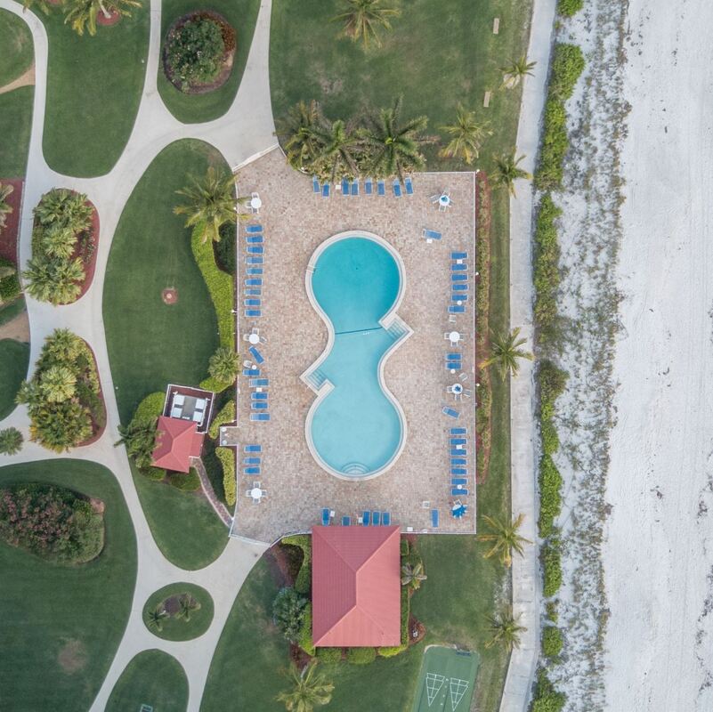 High angle photo of a swimming pool and garden